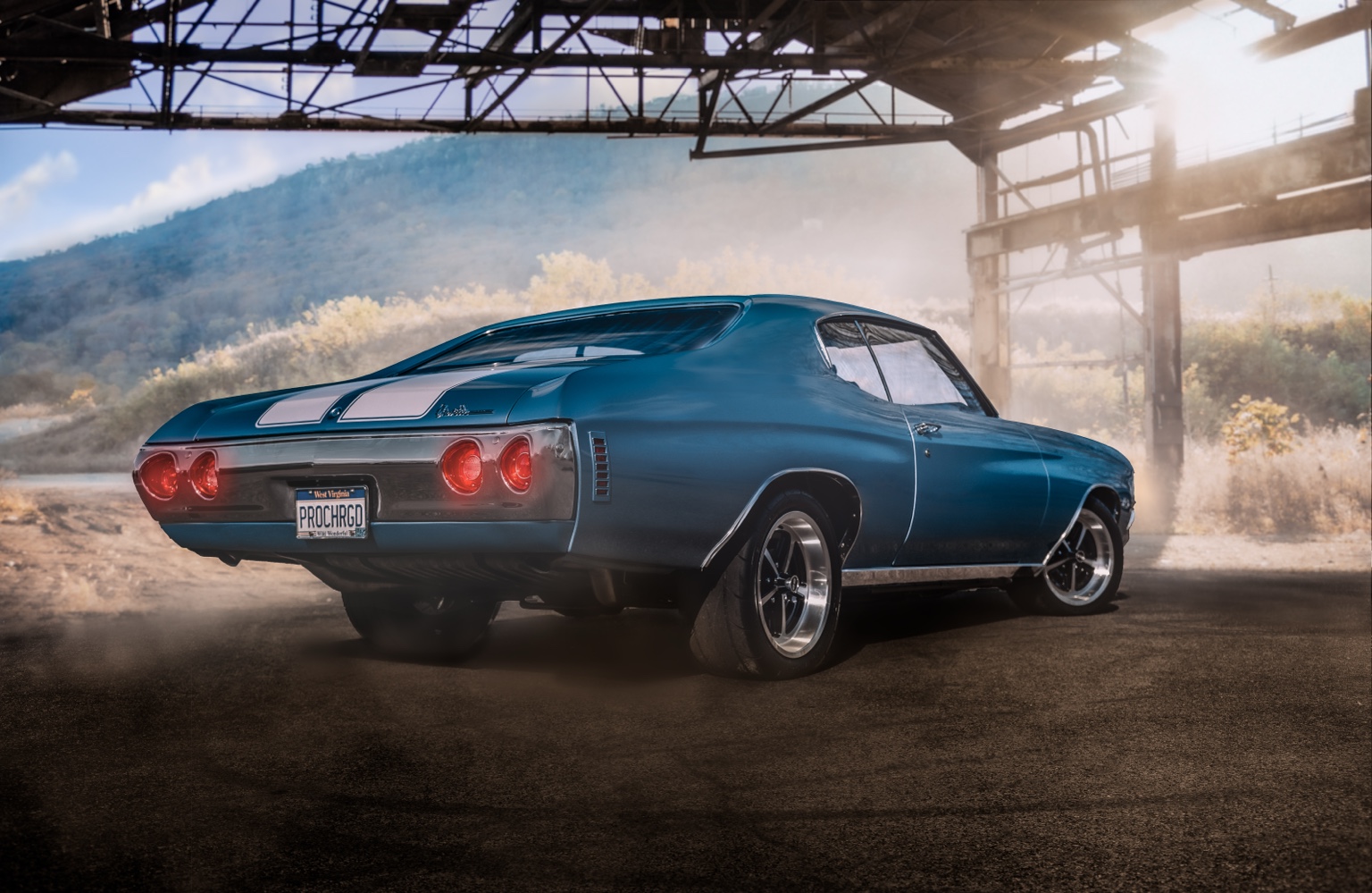 Blue classic Chevrolet Chevelle in a sunlit industrial building
