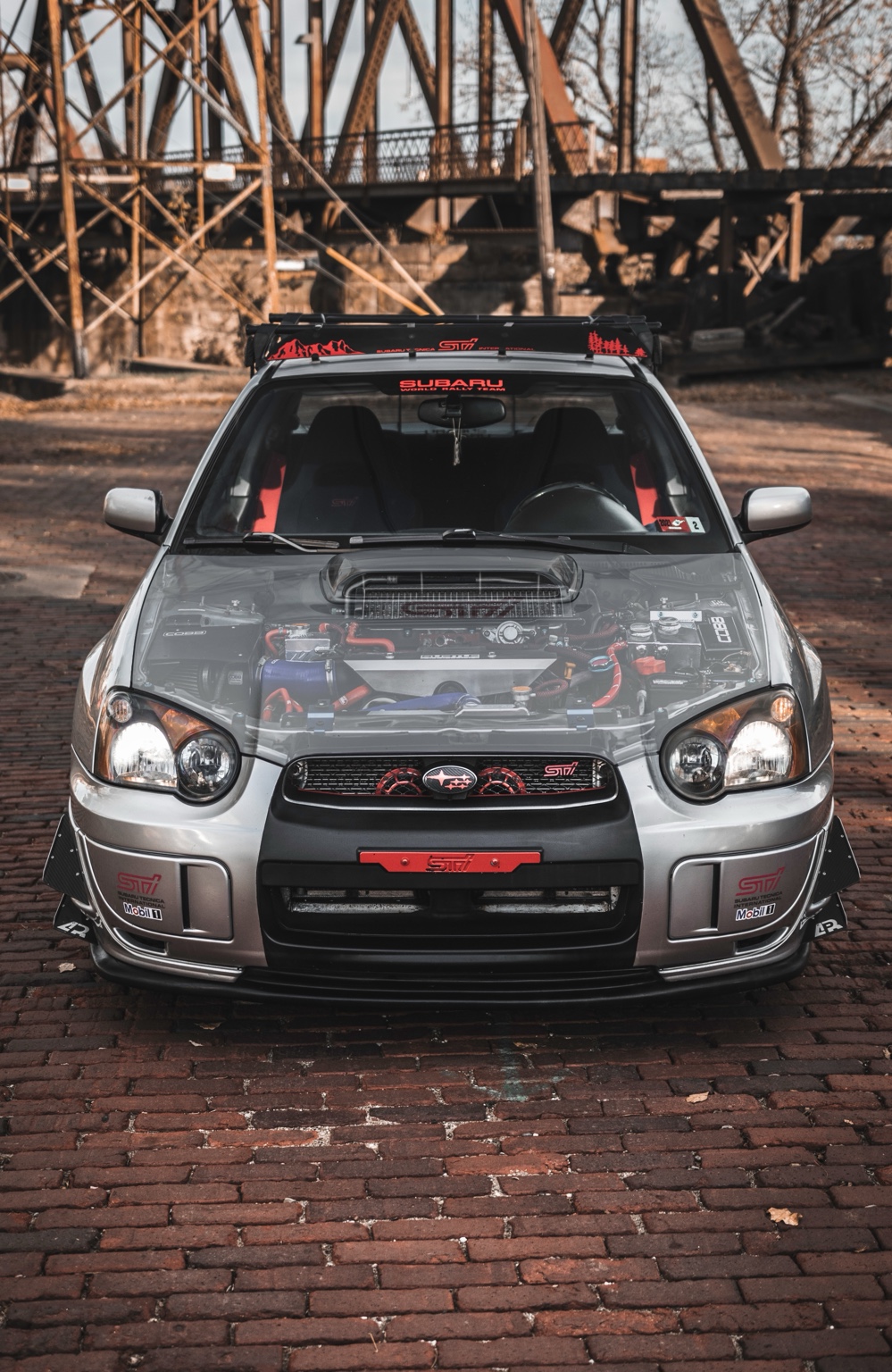 Modified Subaru WRX STI photographed beneath a steel bridge